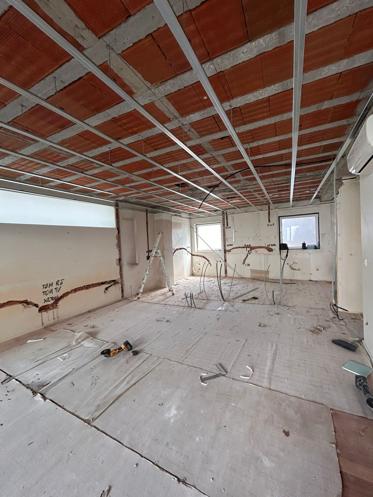 Full strip-out with new ceiling framing and rewiring underway