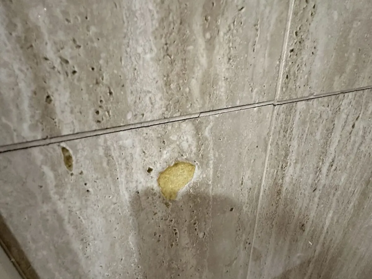 Yellow filler and staining on travertine wall cladding