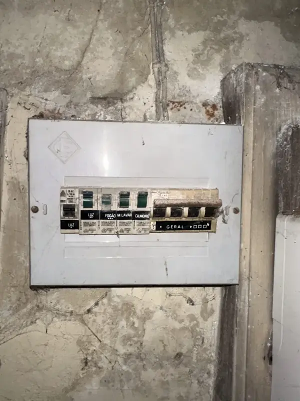 Original distribution board on a stained wall in an older Porto house