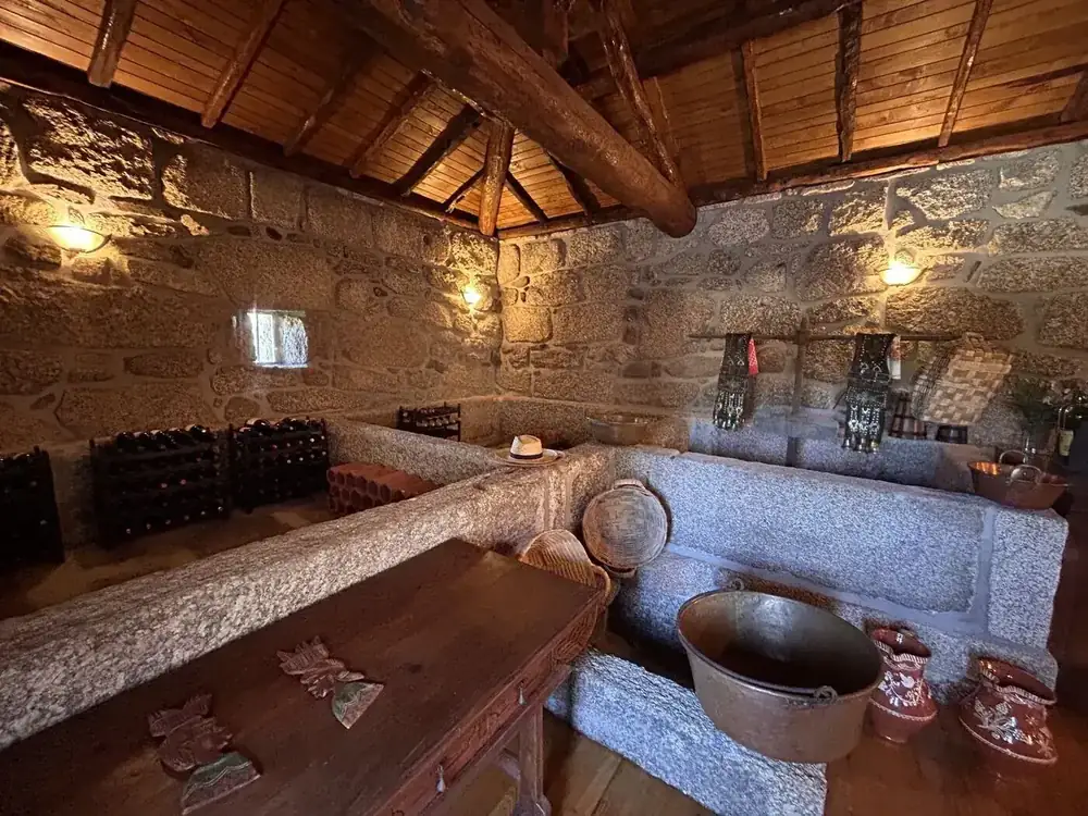 Granite lagar tanks in the adega of a quinta under a round-pole timber roof
