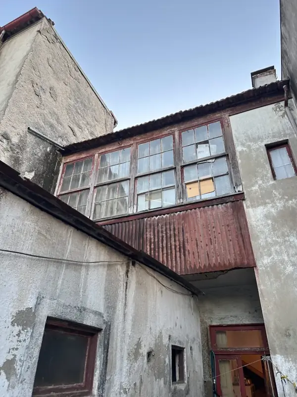 Rear of an old Porto house with an enclosed timber balcony and later extensions