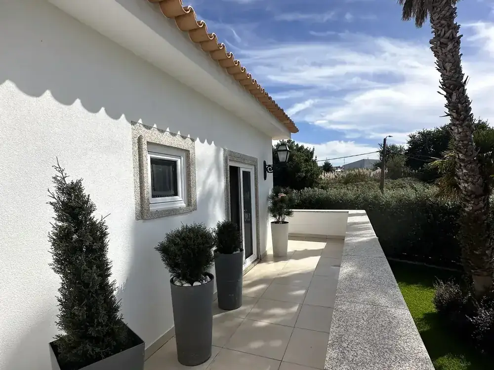 Veranda roof added to a house, with no gutter at the eave