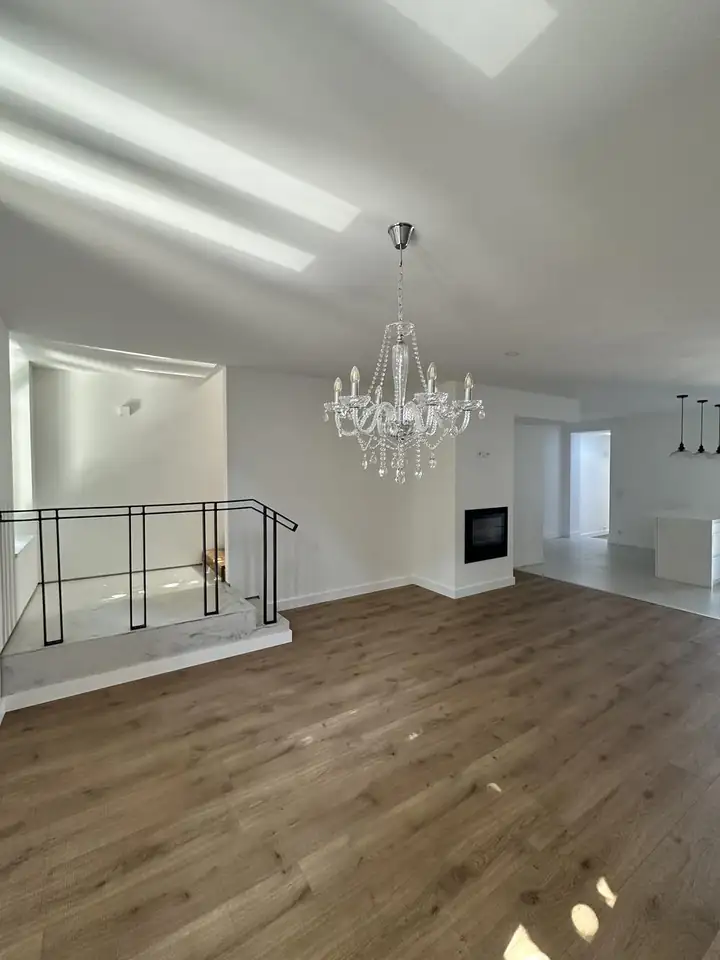 Open-plan living and dining room in a completed Porto renovation with marble stair and inset fireplace
